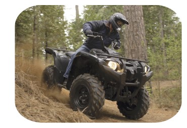 rider on a used atv in the woods